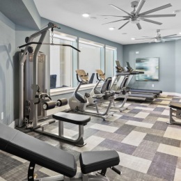 fitness center with open spaces and bright lighting through the windows