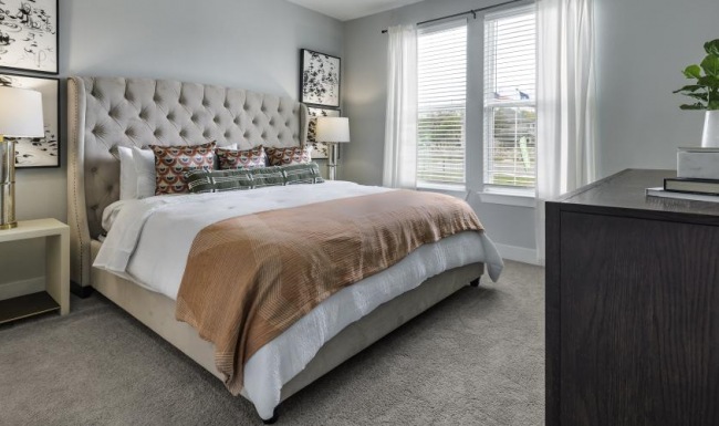 a bedroom with a bed and a fan