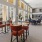 Resident lounge at our senior living community in San Antonio, featuring carpeted flooring and tables with chairs.