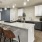 Resident dining area at our 55 and over community in San Antonio, featuring wood grain floor paneling and a refrigerator.